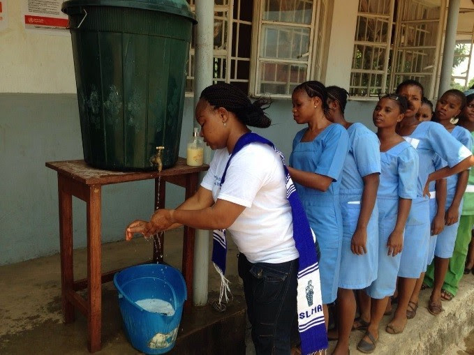 Healthcare workers in Sierra Leone washing their hands