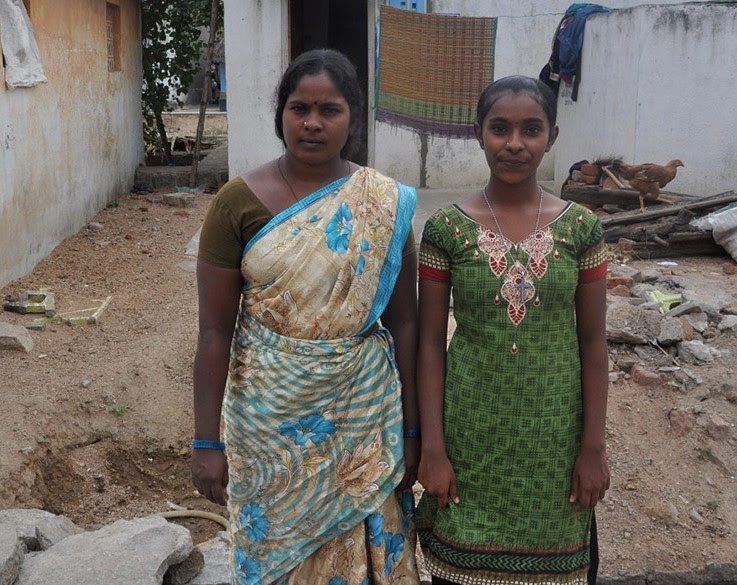 Photo of Tamilarasi and her mother outside their home.