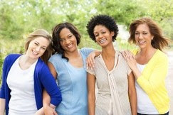 Group of women of all ages smiling. 