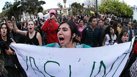 Protesters against the exploration for oil in Ecuador's Yasuni National Park in front of the presidential palace in Quito.