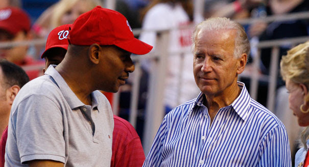 Joe Biden looking at red cap