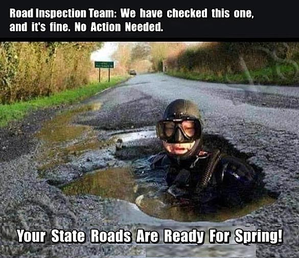 Inspector in a six foot deep pothole declaring the roads safe for spring driving.