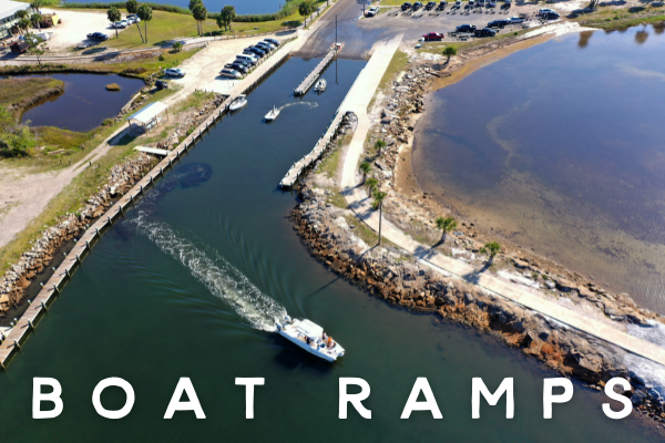 an aerial shot of a boat coming out of the boat ramp