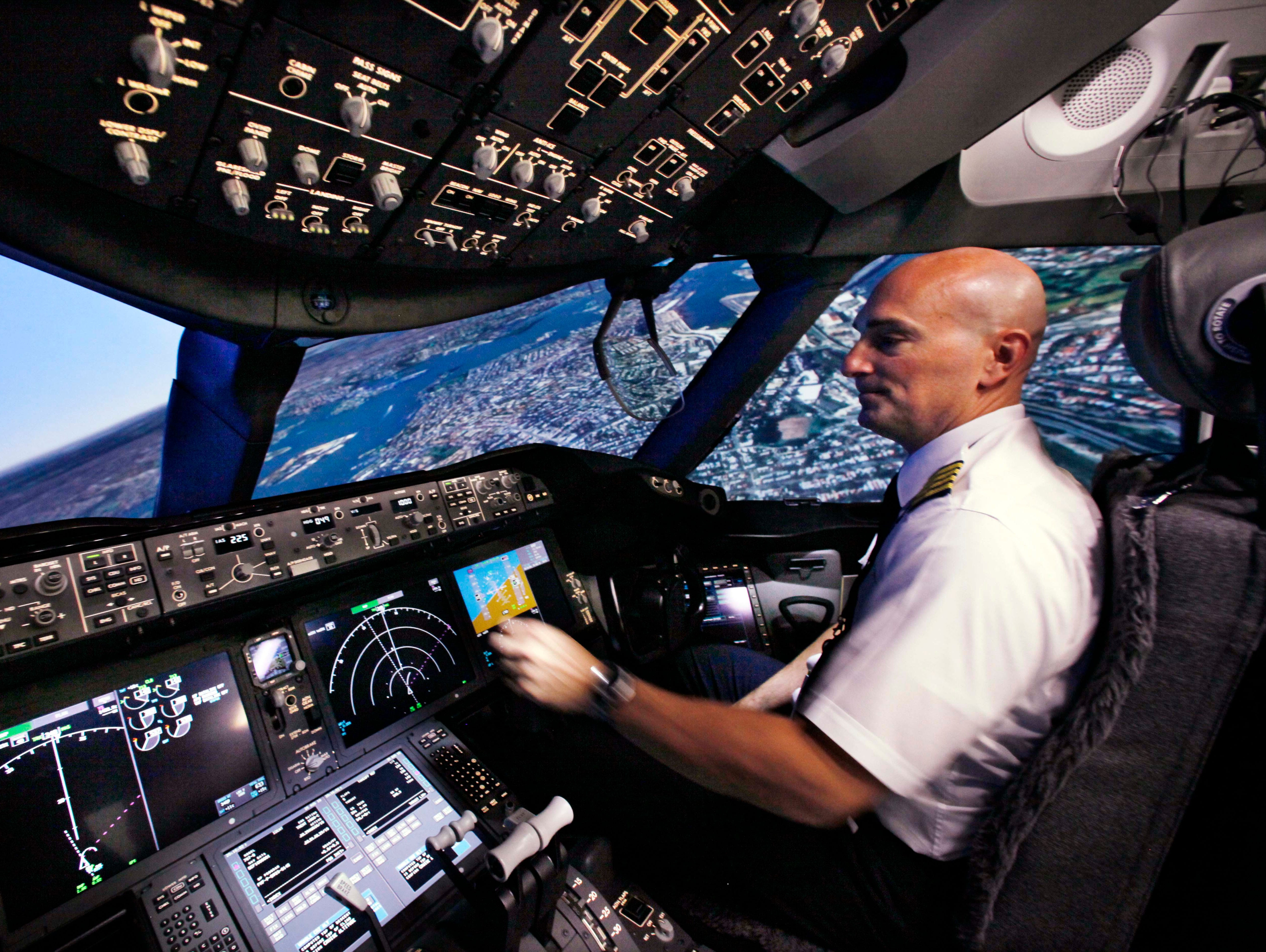 Pilot Gregg Pointon operates a Boeing 787 full-flight simulator during a media tour of the company's training tools on Aug. 26, 2010, in Renton, Wash.