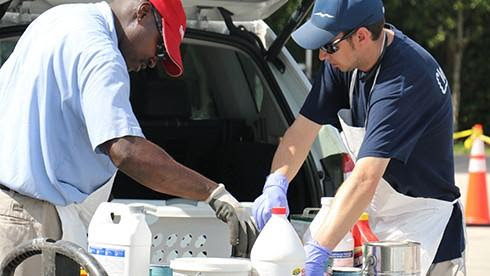 Image of two men handling the collection of hazardous waste for the Household Hazardous Waste Event