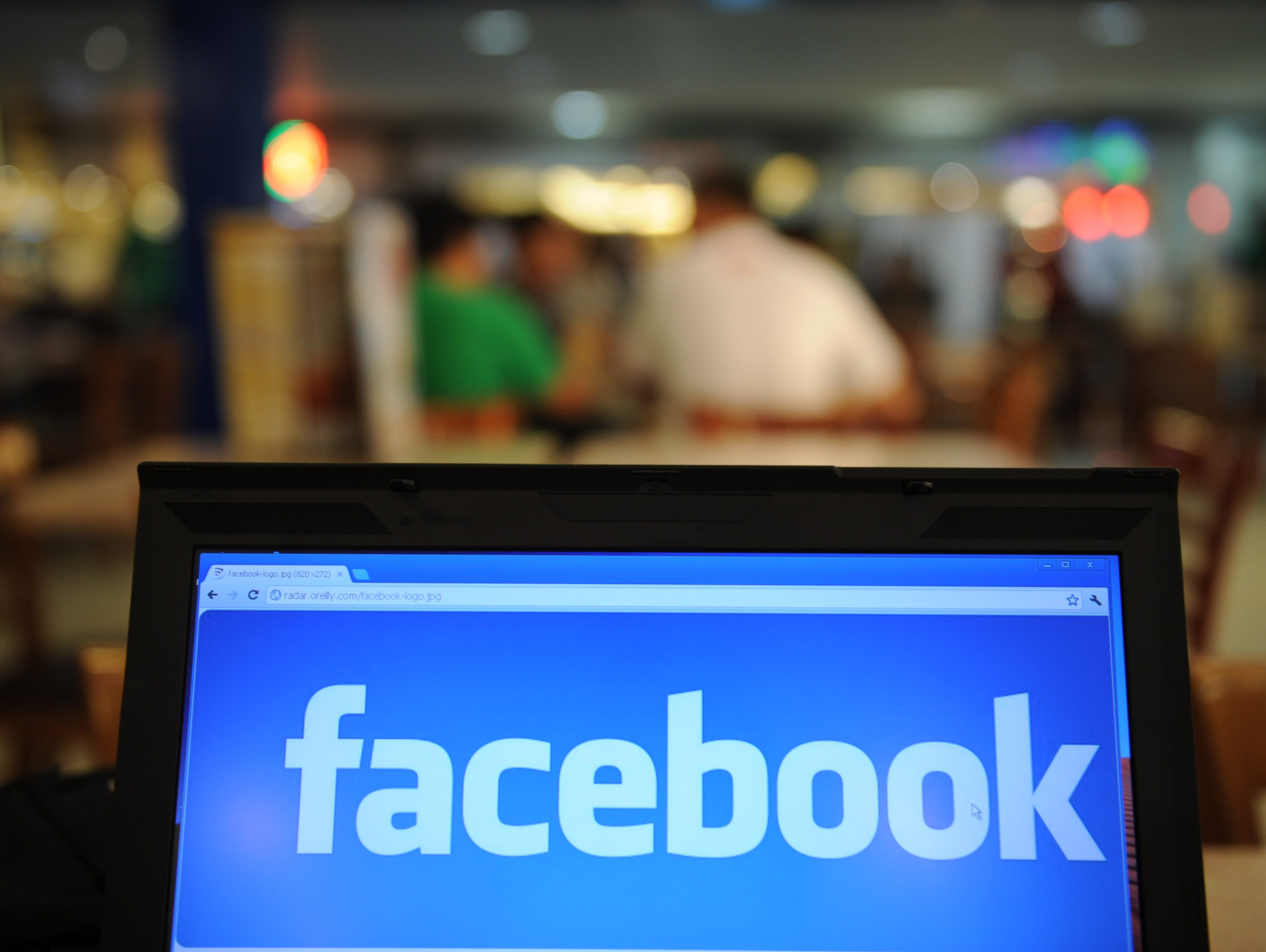 A logo of social networking Facebook is displayed on a laptop screen inside a restaurant in Manila.