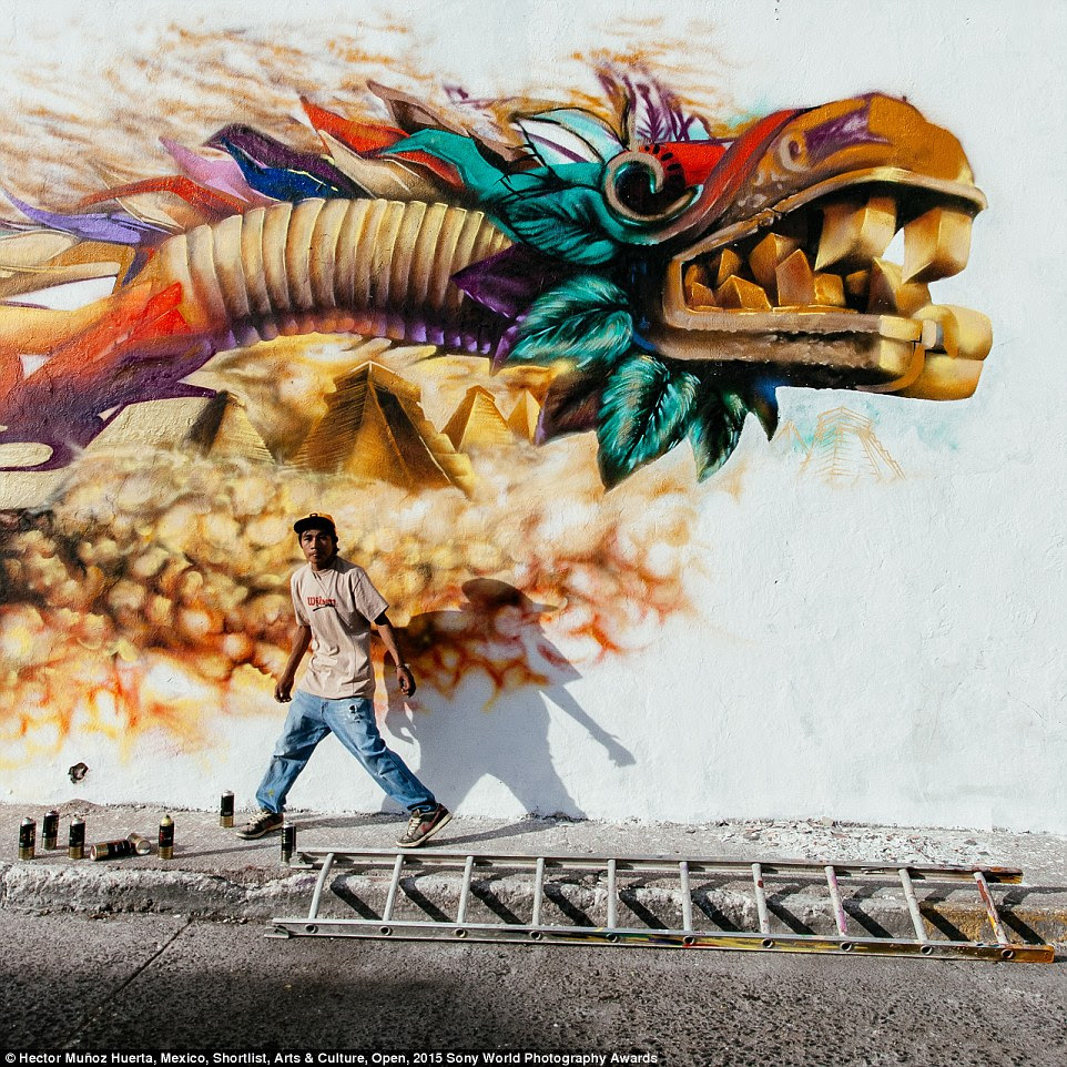 The old and the new: A Mexican grafitti artist works on a Quetzalcoatl, the benign pre-Hispanic God that gave corn and fire to men
