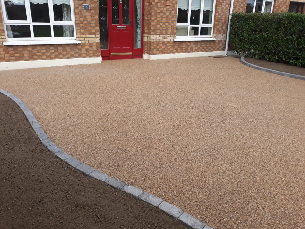 Existing concrete driveway and a sandstone pathway created through the middle of the driveway in a curved line. Resin Bound Gravel Driveway In Celbridge Micheal Quinn Landscaping
