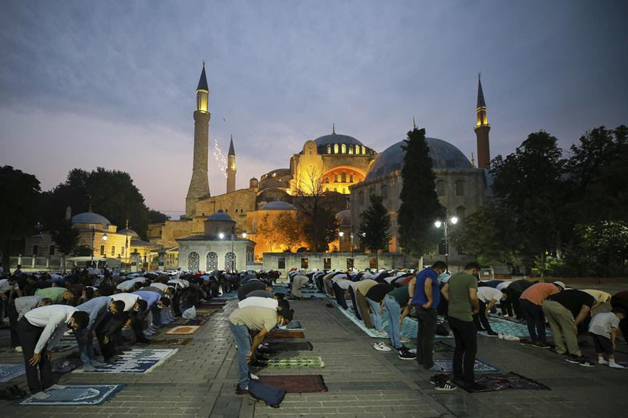 Muslims offer prayers during the first day of Eid al-Adha, outside the iconic Haghia Sophia in the historic Sultan Ahmed district of Istanbul, Tuesday, July 20, 2021.