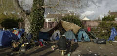 A migrant sits in a makeshift camp outside Calais, northern France, Saturday, Nov. 27, 2021. At the makeshift camps outside Calais, migrants are digging in, waiting for the chance to make a dash across the English Channel despite the news that at least 27 people died this week when their boat sank a few miles from the French coast. (AP Photo/Rafael Yaghobzadeh)/XTC129/21331582400006//2111280955