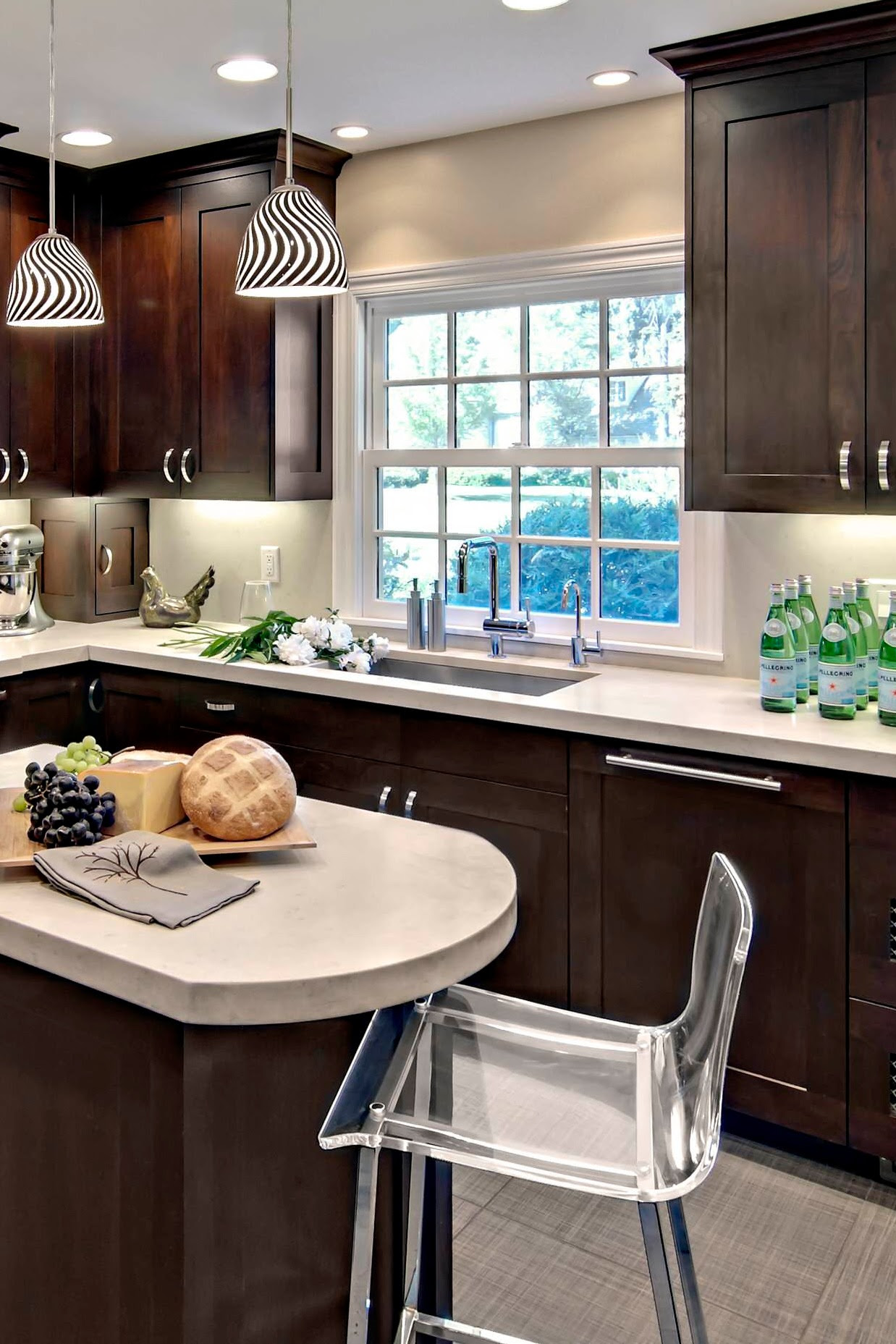 This kitchen with dark kitchen cabinets and a white quartz countertop has a stone mosaic backsplash that fits in perfectly. Dark Kitchen Cabinets With Light Countertops Home Designs