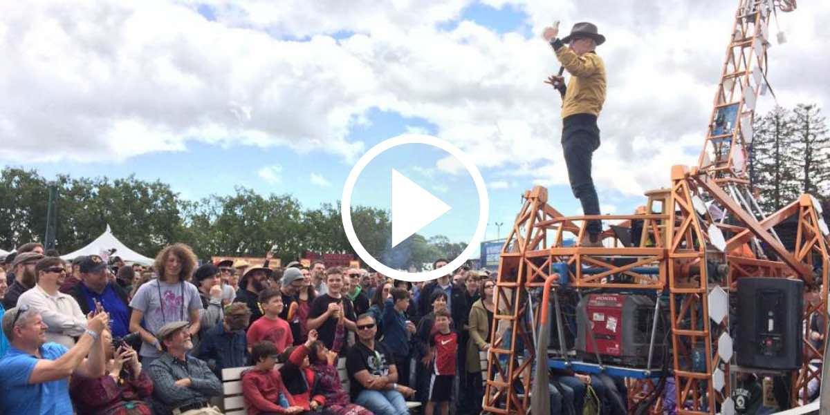 Adam Savage rides the giraffe at Maker Faire