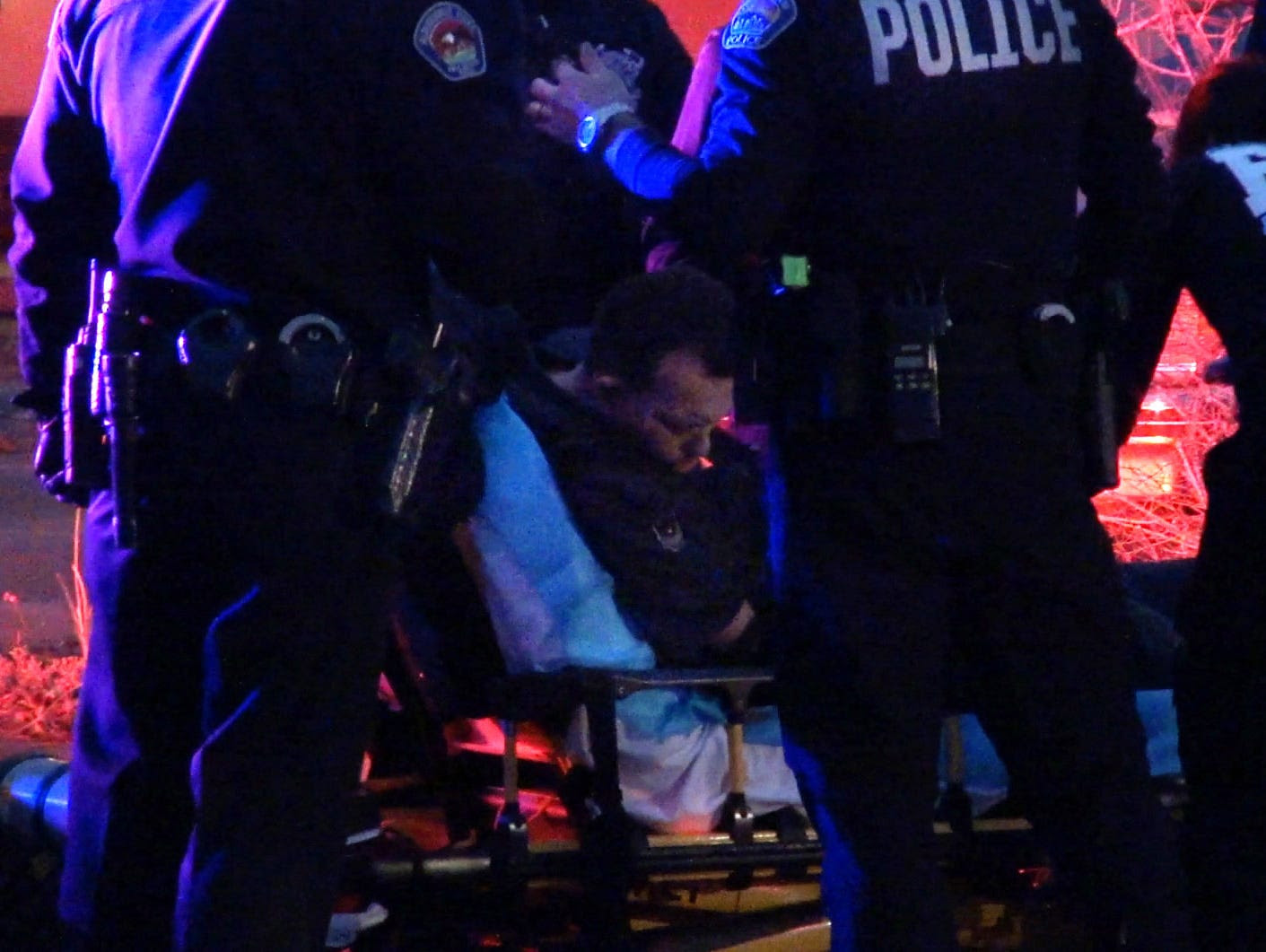 In this frame grab taken from video, medical personal assist a man before transporting him to an ambulance in Albuquerque, N.M., Tuesday, Jan. 13, 2015.