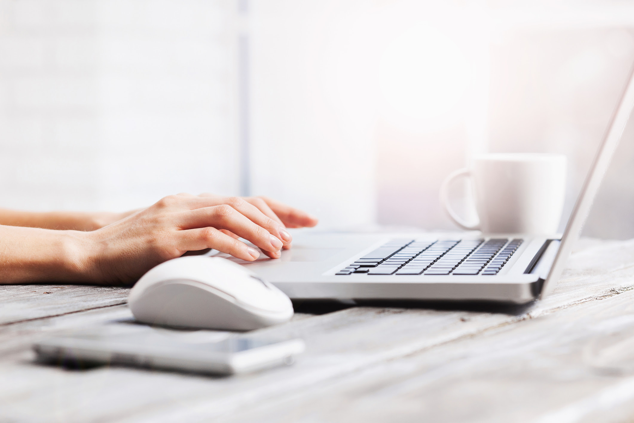 Close-up of female hands on laptop keyboard