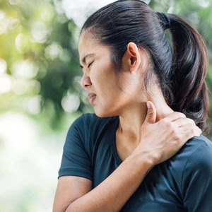Woman holding her neck. Fibromyalgia Research Spotlight 