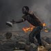 A protester in Bujumbura, Burundi, added to a barricade at a demonstration against the country's president on Friday