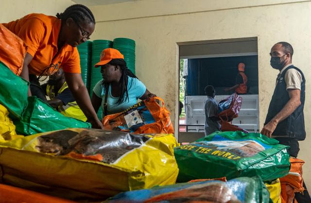 Photo of workers in Haiti receiving and sorting aid packages.