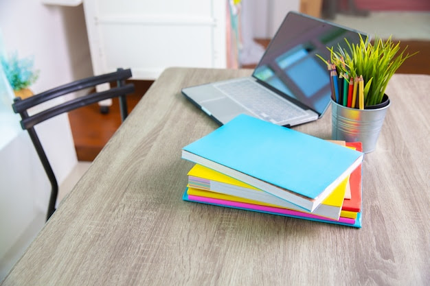 Books and computer on table