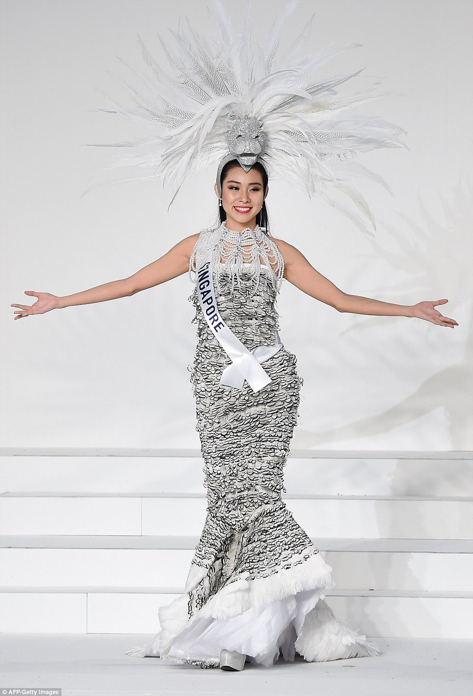 Miss Singapore came dressed as the country's mascot, the half-lion half-fish Merlion. Covered in silver scales, Roxanne Zhang's fish tail breaks into white feathers, which look like a bit like flaked white fish meat, which we guess was the desired effect. Wearing an extravagant pearl necklace, her sparkly lion headdress has a mane of white and black and white striped feathers.