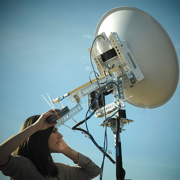 Jessica Frantz holding an atmospheric sampling receiver