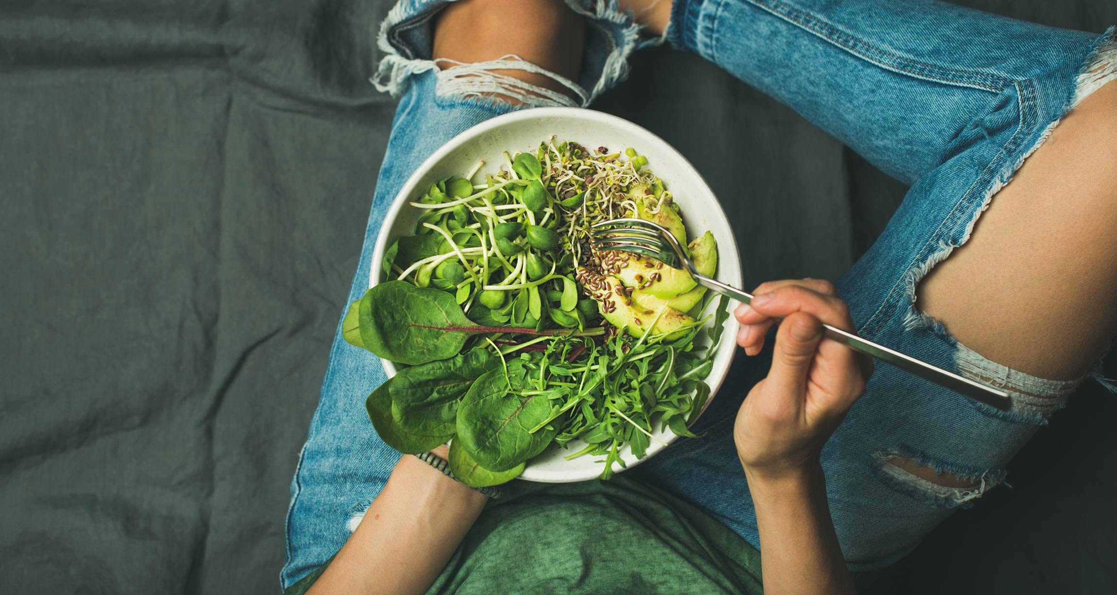 GBOMBS - woman's lap holding a bowl of greens