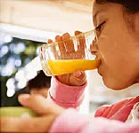 Girl drinking orange juice