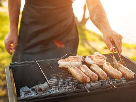 Photo of a man cooking a BBQ