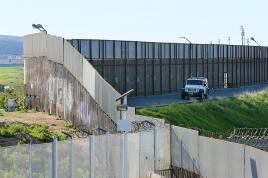 A Border Patrol vehicle sits along the US-Mexico border wall in San Ysidro, California