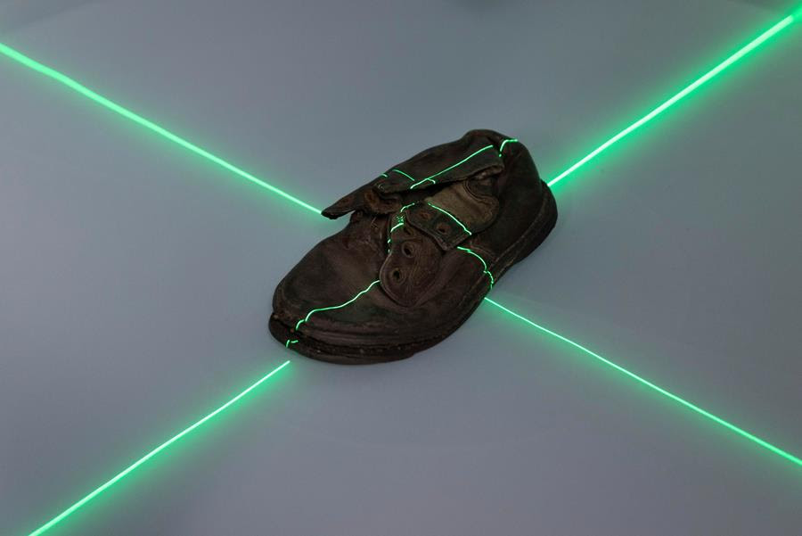 shoe that belonged to a child victim of the former Nazi German death camp Auschwitz-Birkenau is scanned at the conservation laboratory on the grounds of the camp in Oswiecim, Poland.