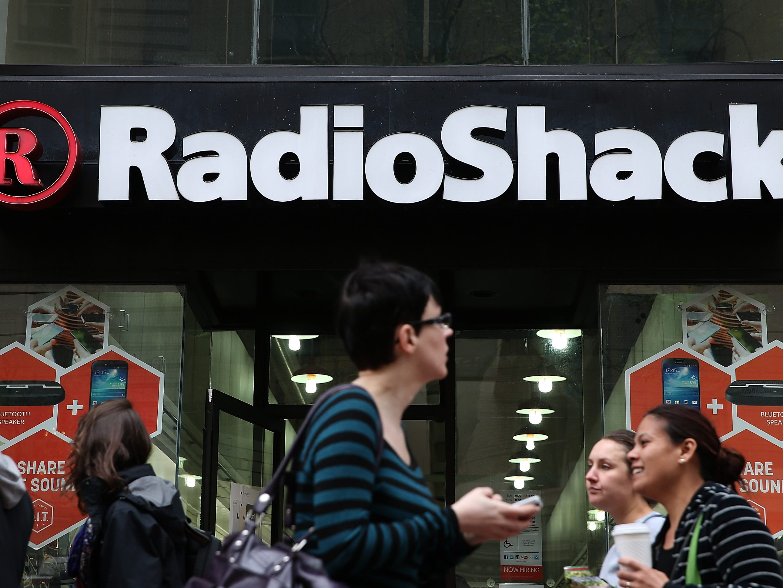 People walk by a Radio Shack store on March 4, 2014 in San Francisco, California. RadioShack announced plans to close over 1,000 of its underperforming stores, approximately 20 percent of its retail locations, as part of a restructuring to be more co